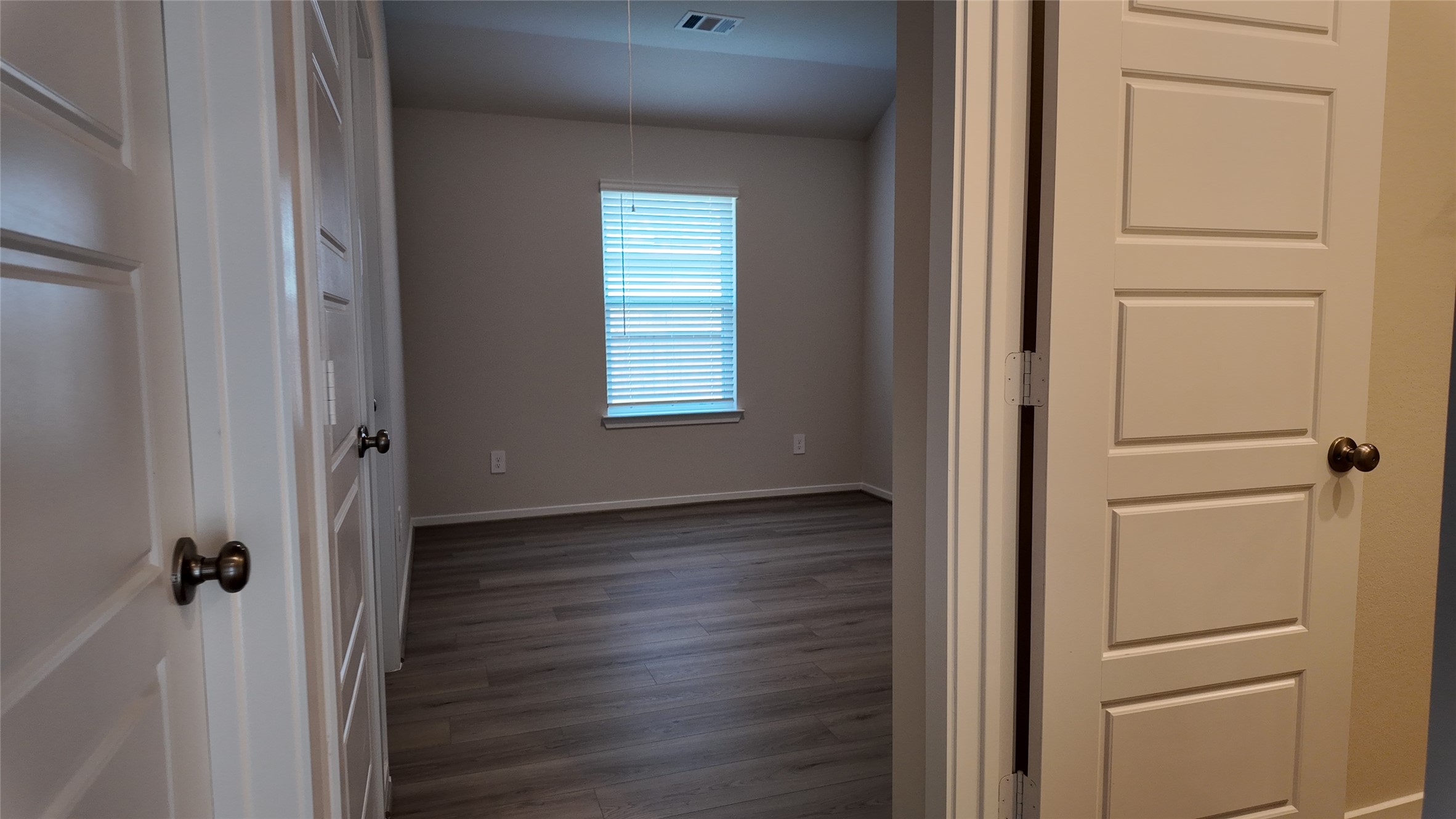 16241 Parish Pointe Court Conroe, TX 77302 - Photo 13 of 25 a view of a hallway with wooden floor and closet area