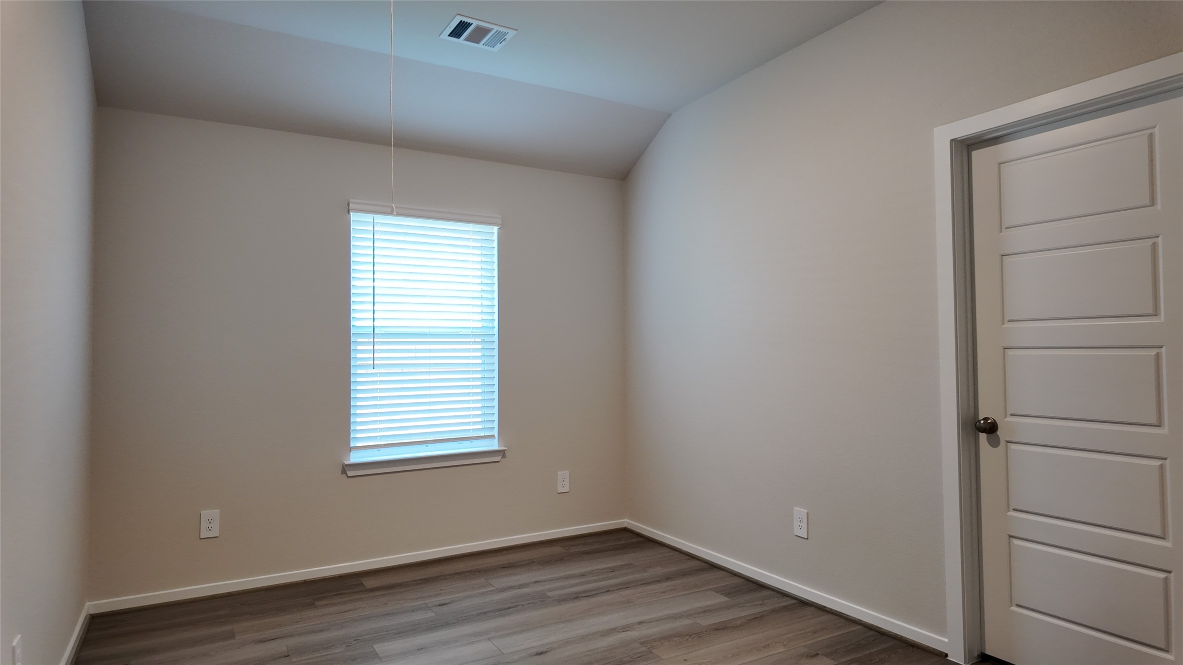 16241 Parish Pointe Court Conroe, TX 77302 - Photo 14 of 25 a view of an empty room with wooden floor and a window