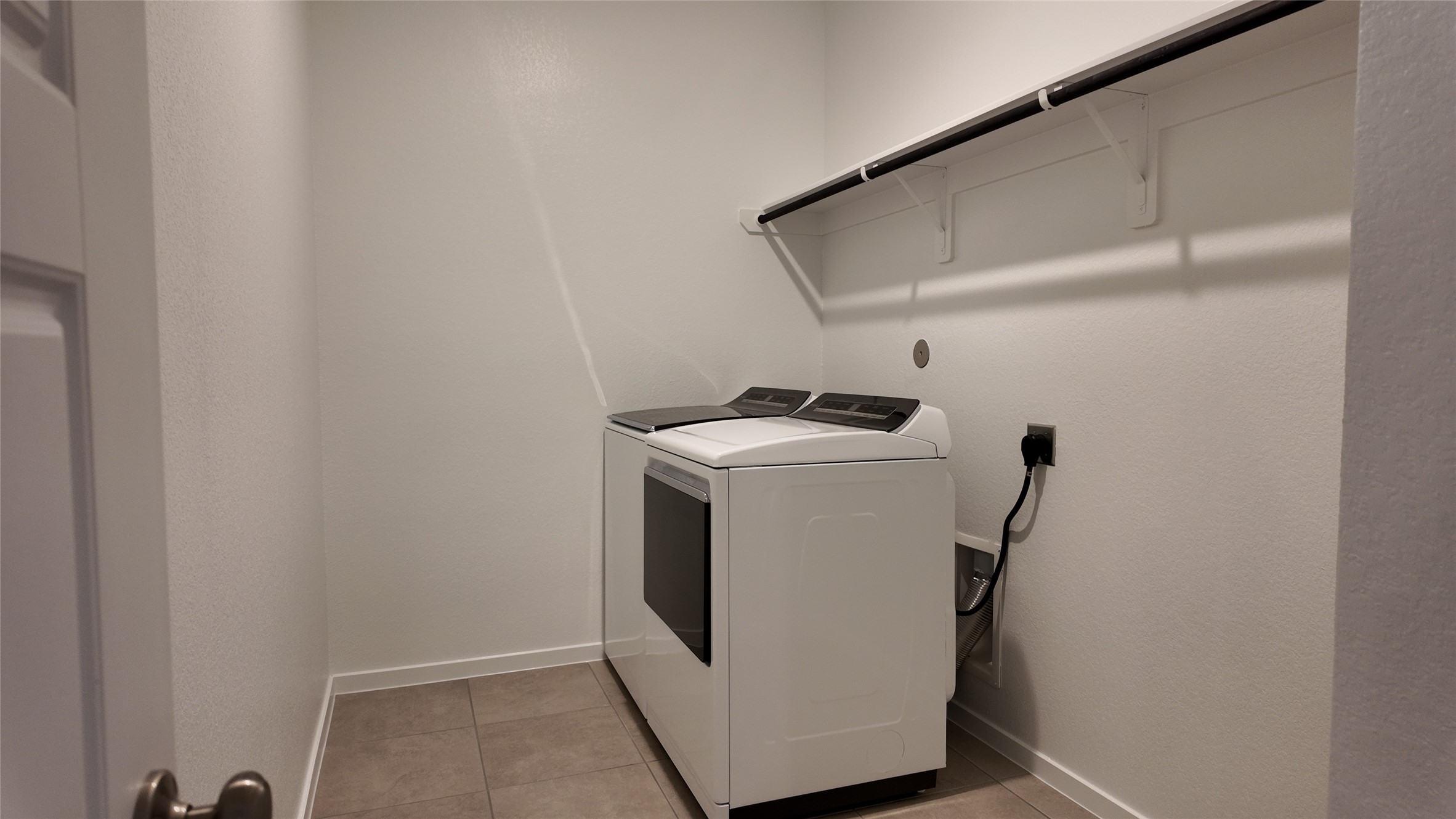 16241 Parish Pointe Court Conroe, TX 77302 - Photo 18 of 25 a utility room with dryer and washer
