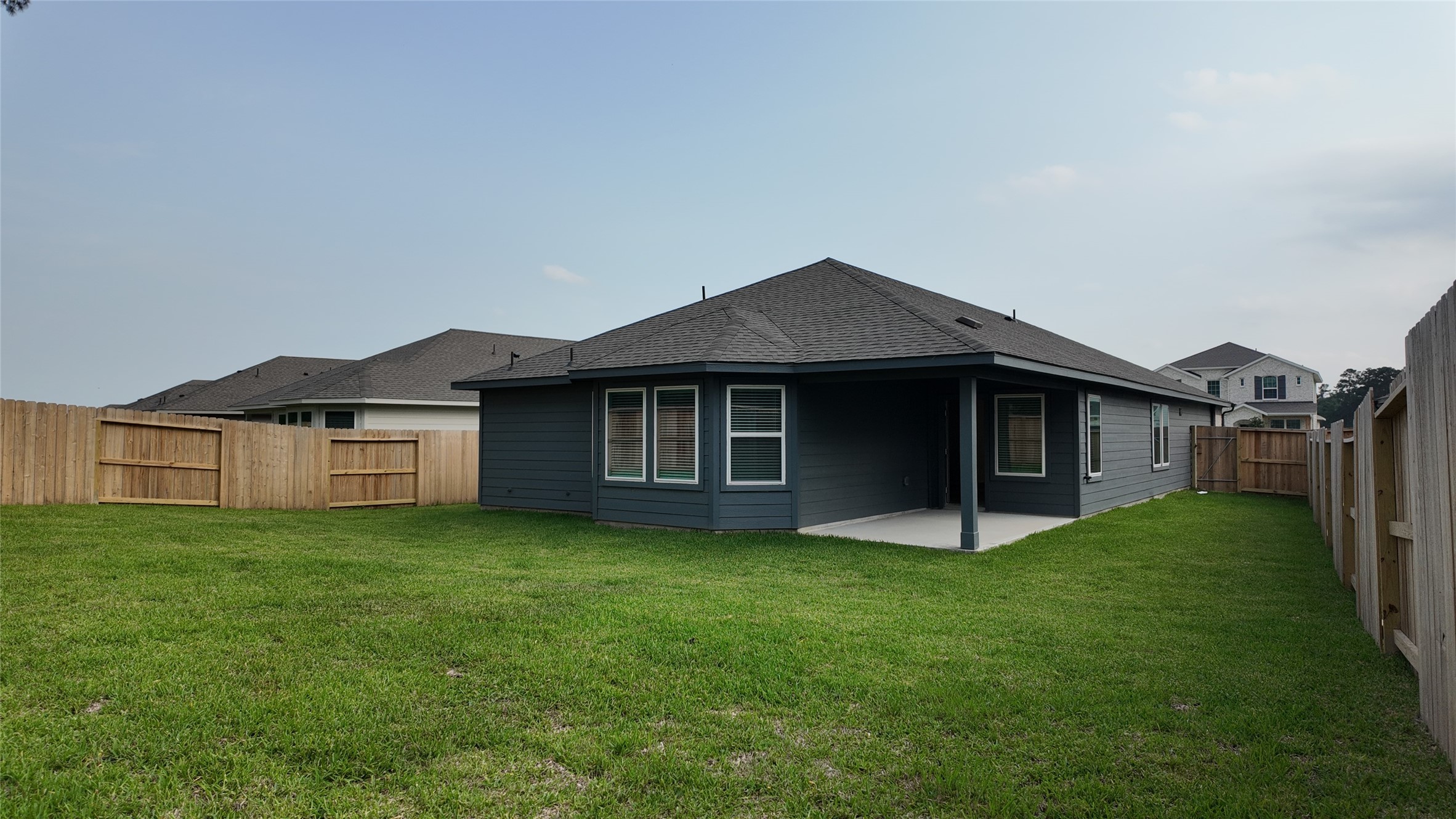 16241 Parish Pointe Court Conroe, TX 77302 - Photo 25 of 25 a house that has a big yard with wooden fence