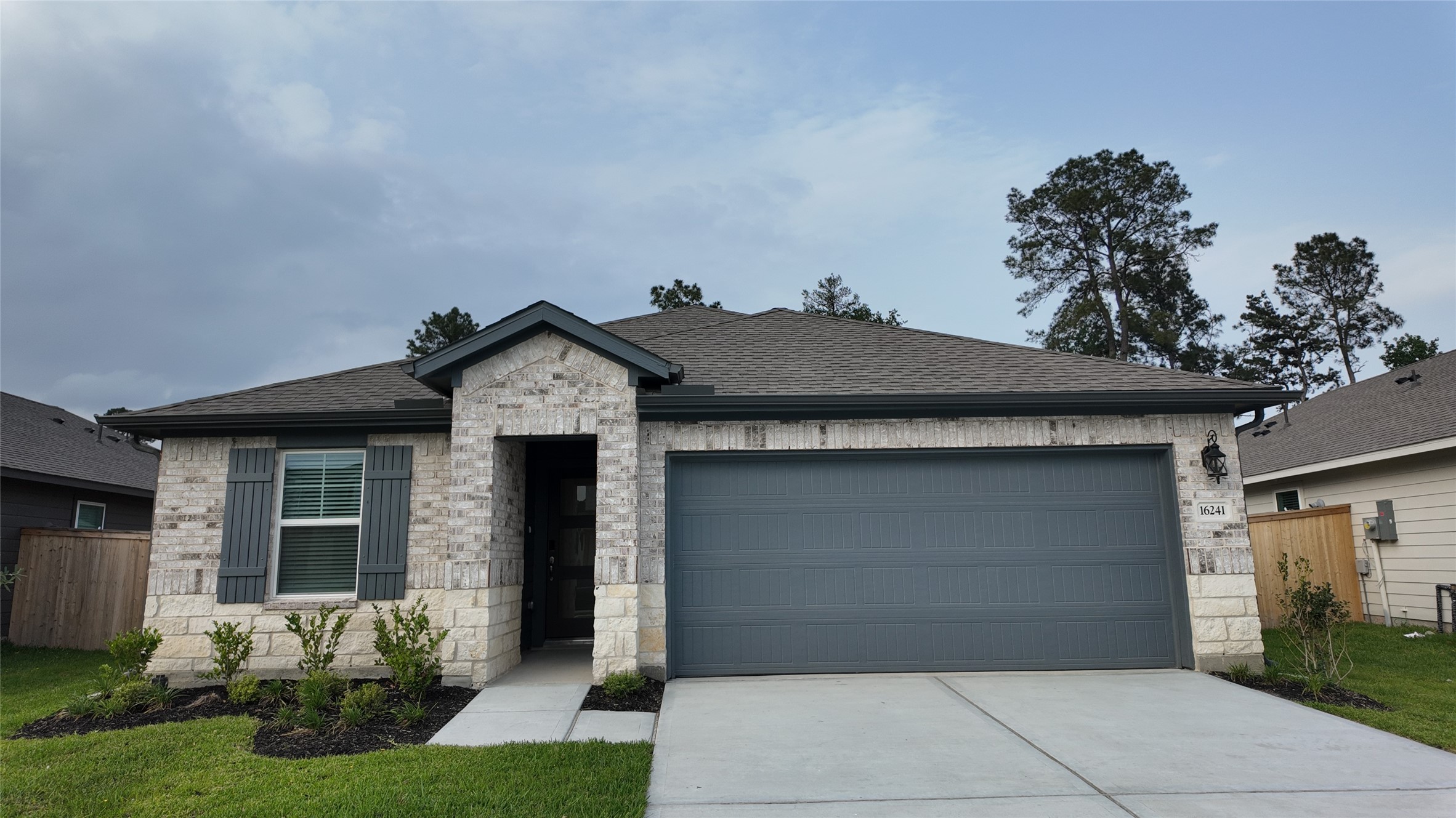 16241 Parish Pointe Court Conroe, TX 77302 - Photo 3 of 25 a front view of a house with garden