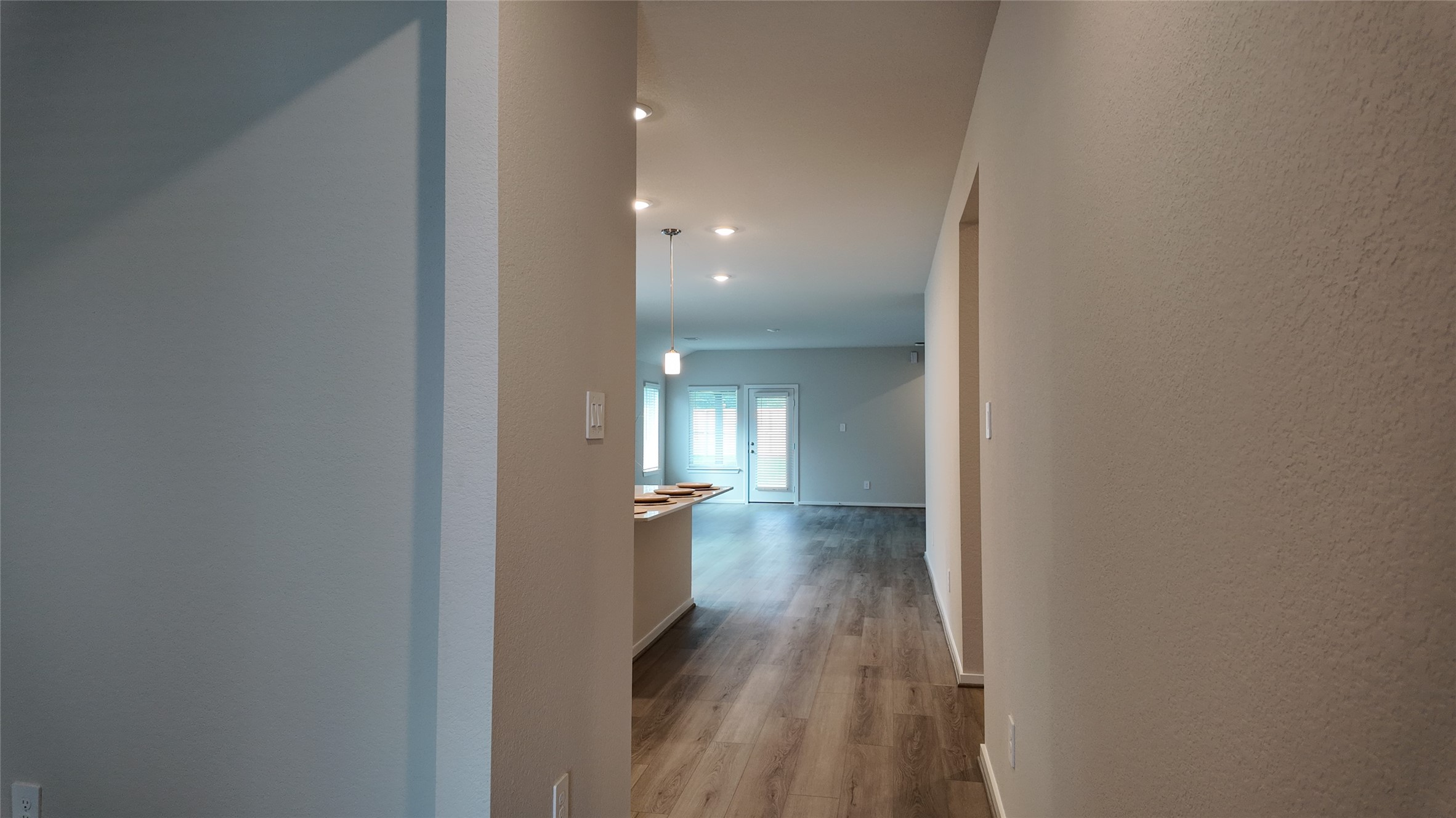 16241 Parish Pointe Court Conroe, TX 77302 - Photo 4 of 25 a view of a hallway with wooden floor and a bathroom