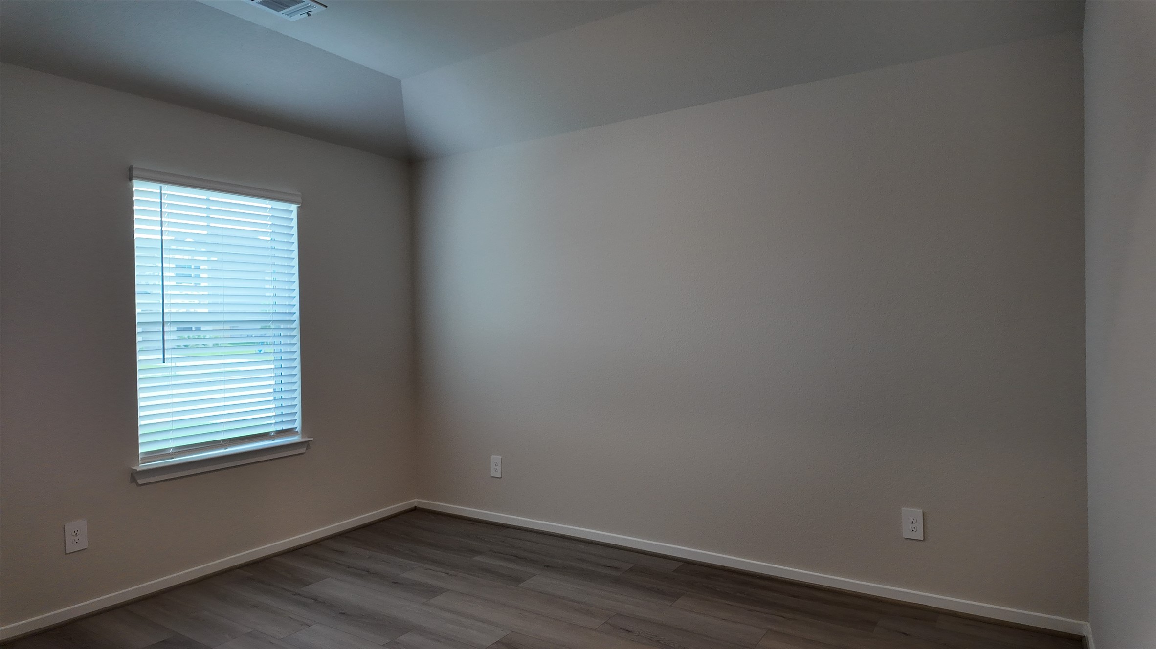 16241 Parish Pointe Court Conroe, TX 77302 - Photo 5 of 25 a view of an empty room with wooden floor and a window