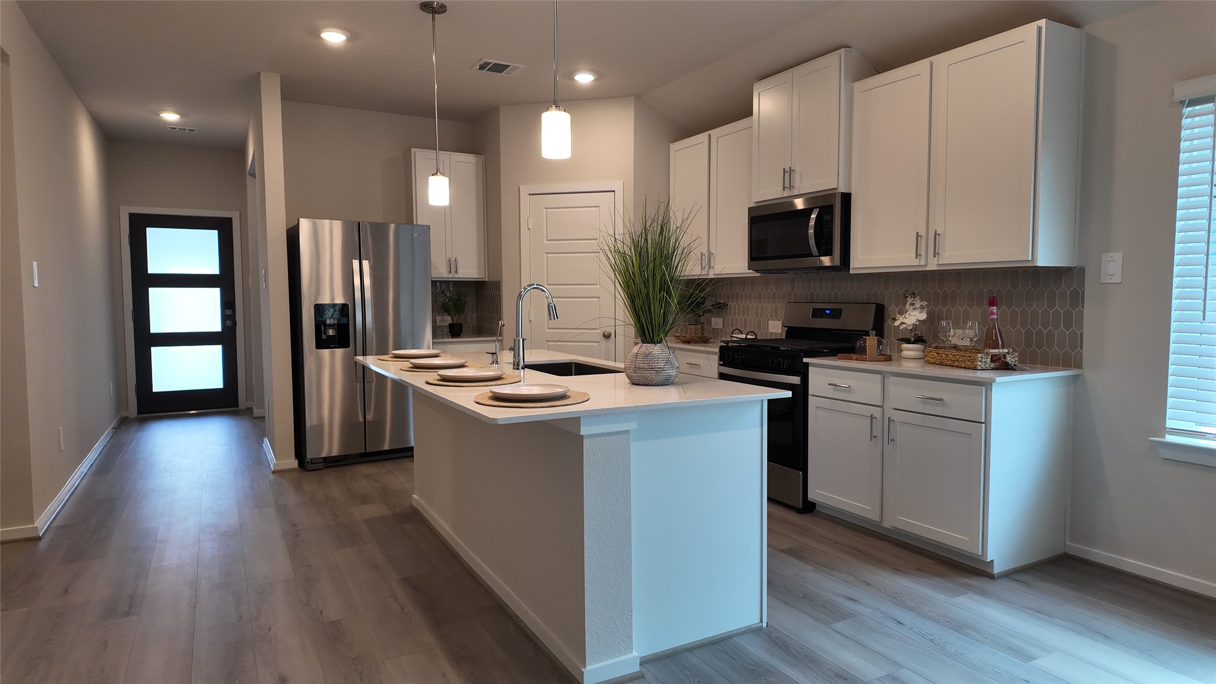 16241 Parish Pointe Court Conroe, TX 77302 - Photo 7 of 25 a kitchen with kitchen island sink stove and refrigerator