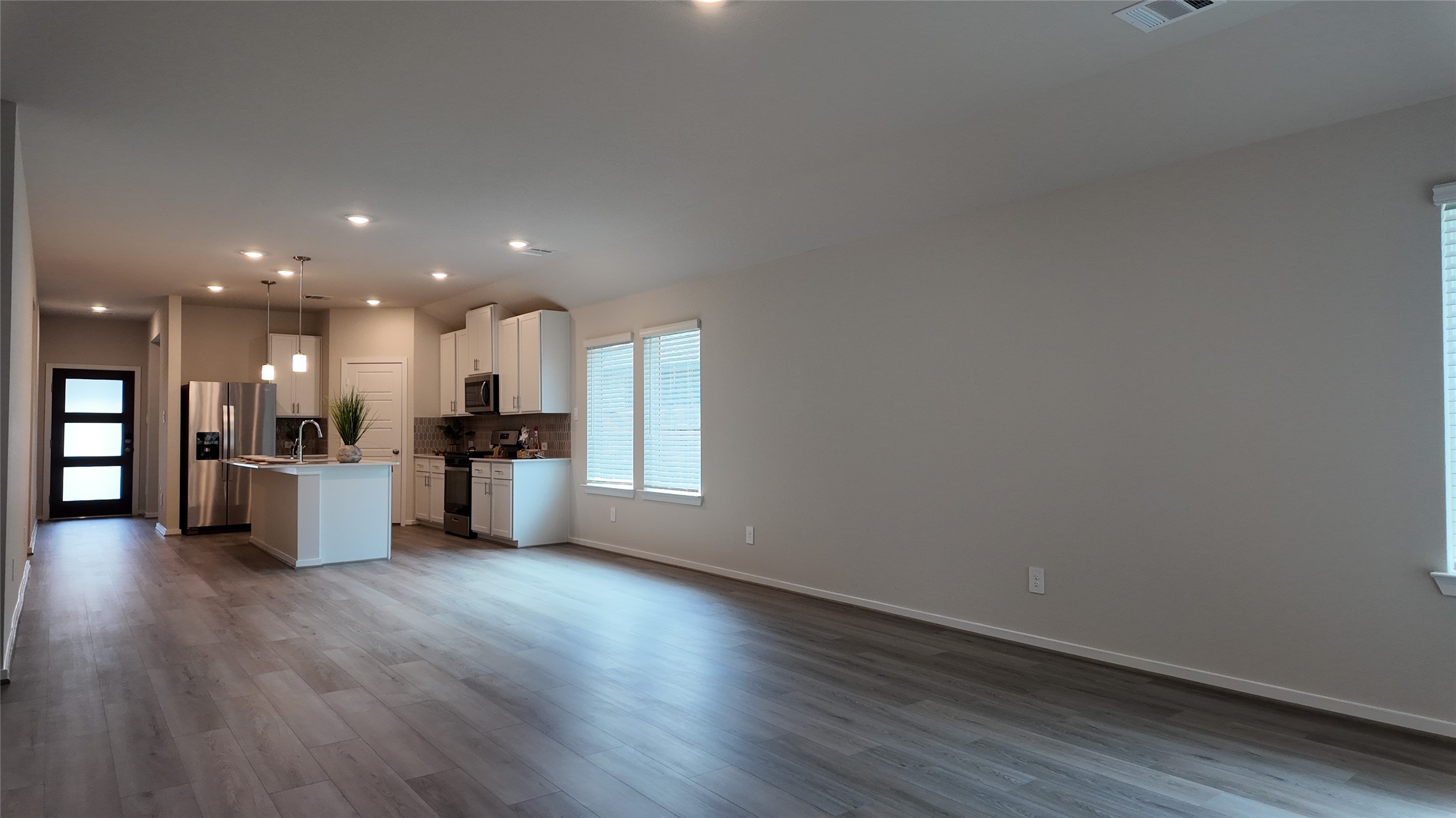 16241 Parish Pointe Court Conroe, TX 77302 - Photo 9 of 25 a view of kitchen with wooden floor and windows