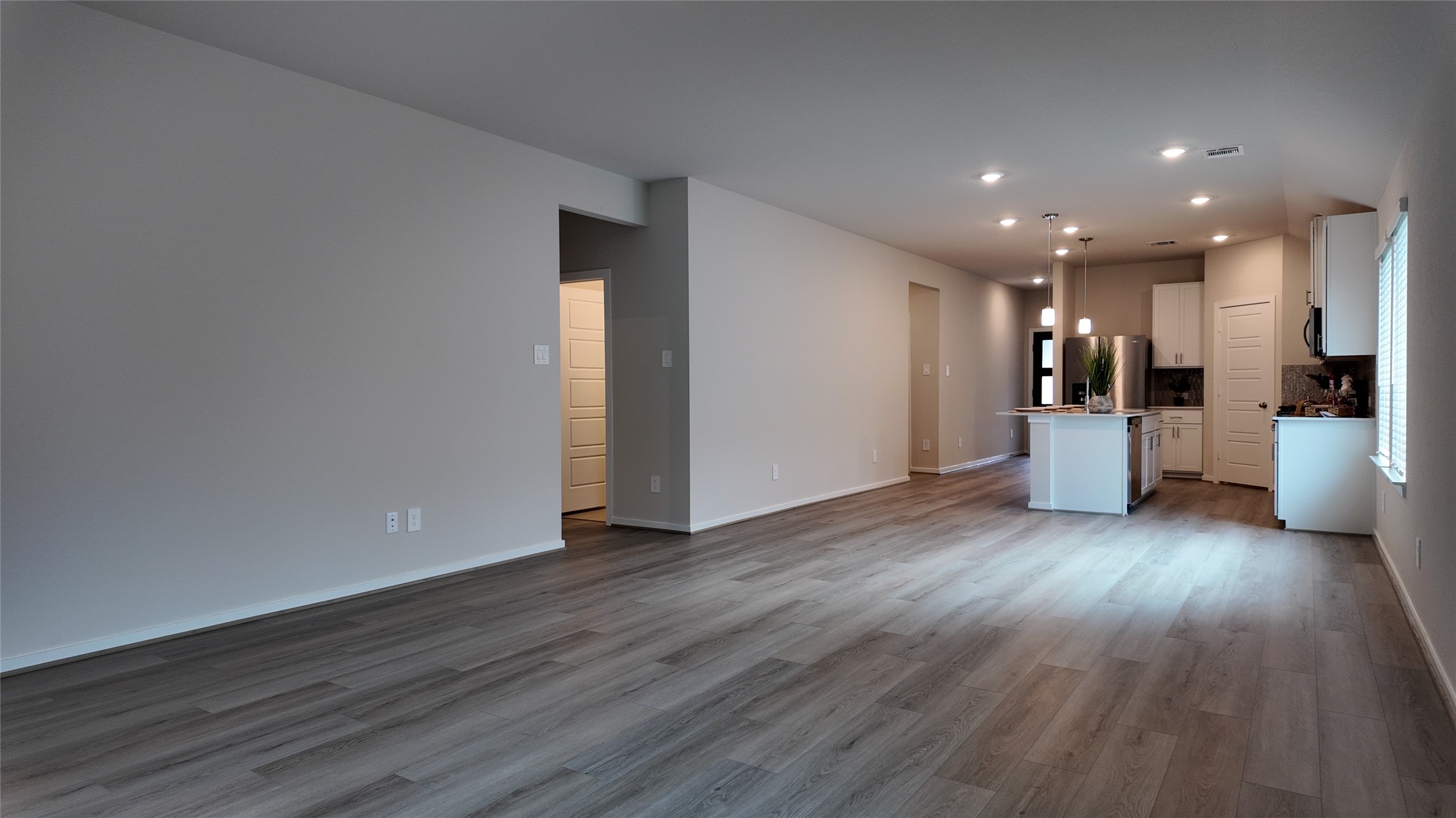 16241 Parish Pointe Court Conroe, TX 77302 - Photo 10 of 25 a view of a kitchen with wooden floor and a refrigerator