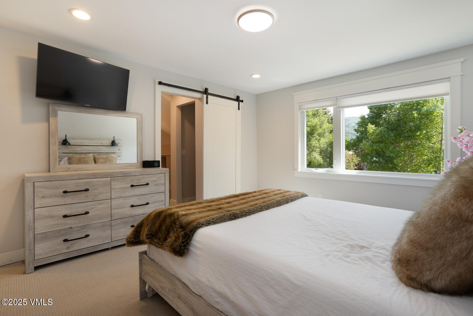 50 Hereford Road Edwards, CO 81632 - Photo 12 of 36 a bedroom with a bed and a flat screen tv