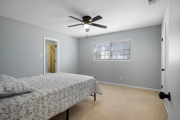 a bedroom with a bed and window