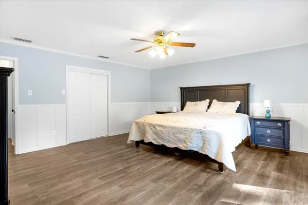 a bedroom with a bed and a chandelier