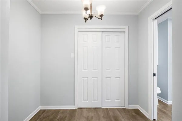 an empty room with windows and cabinet