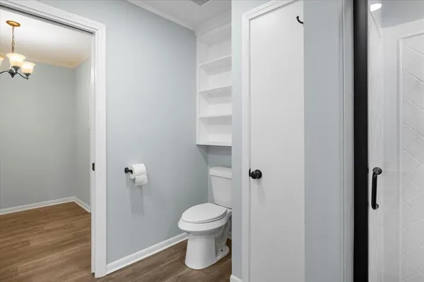 a bathroom with a toilet and a shower