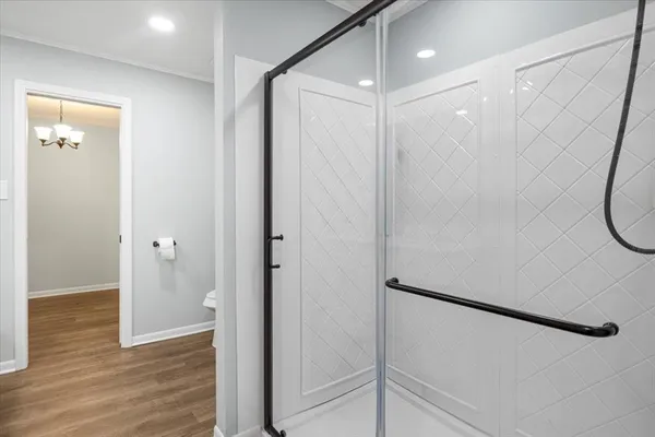a bathroom with a shower and a mirror