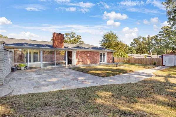 a view of a house with swimming pool and sitting area