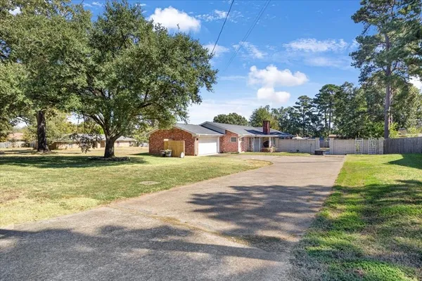 a yellow house with trees in front of it