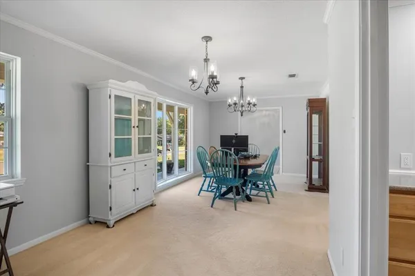 a view of a dining room with furniture and window