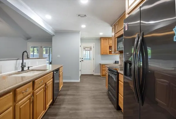 a kitchen with stainless steel appliances granite countertop a refrigerator and a sink