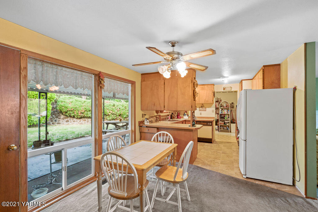 11417 Summitview Road Yakima, WA 98908 - Photo 11 of 26 a view of a dining room with furniture a chandelier and large windows