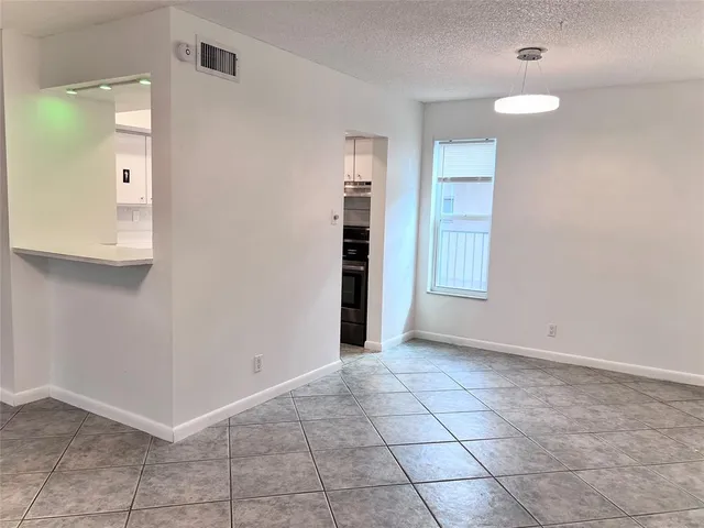 a kitchen with granite countertop white cabinets and black appliances