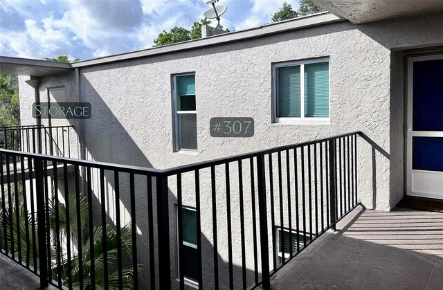 a view of a balcony with wooden floor and fence