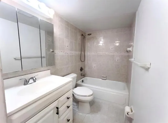 an empty room with wooden floor and a window