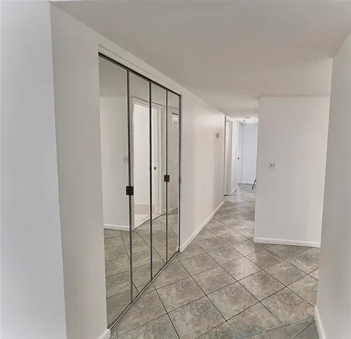 an empty room with windows and entrance