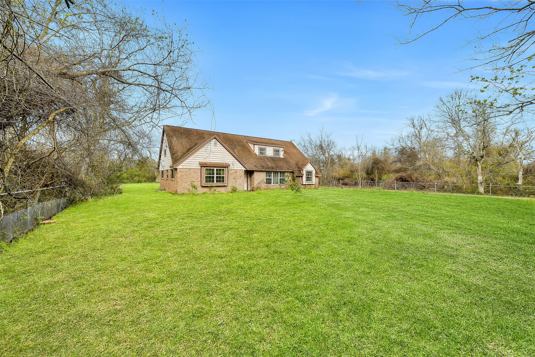 4918 Farmer Road Alvin, TX 77511 - Photo 11 of 18 a view of a green field with house in the background