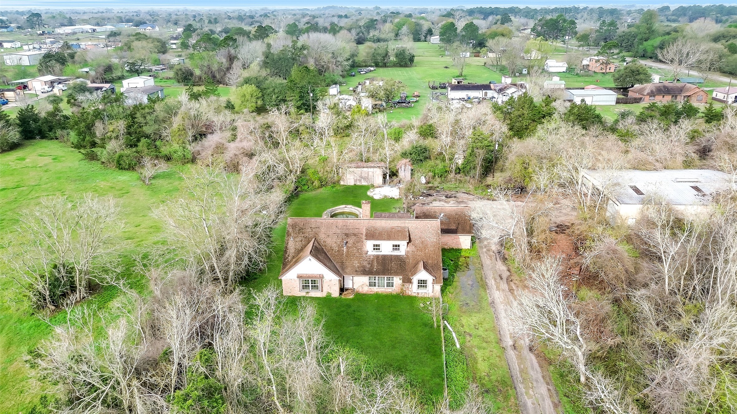 4918 Farmer Road Alvin, TX 77511 - Photo 4 of 18 an aerial view of residential houses with outdoor space and trees