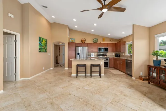a open kitchen with cabinets and stainless steel appliances