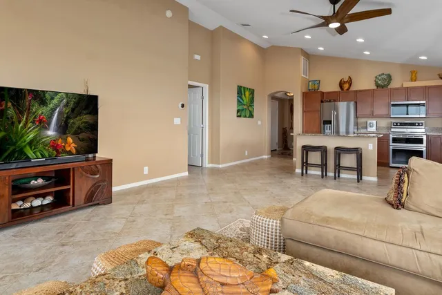 a living room with furniture and kitchen view