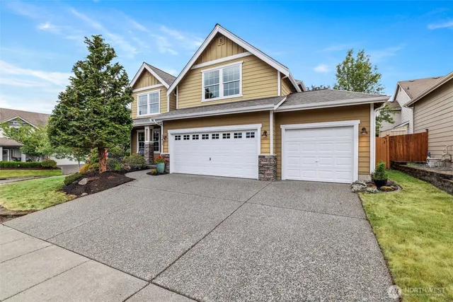 a front view of a house with a yard and garage