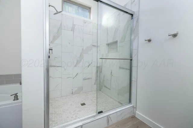 a bathroom with a glass shower door