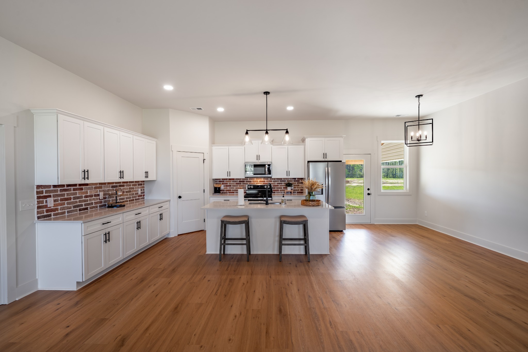 4031 Wells Road Springfield, TN 37172 - Photo 12 of 39 a kitchen with sink cabinets and wooden floor