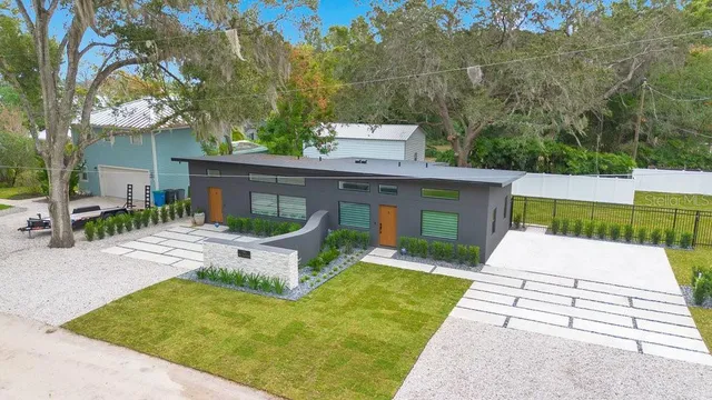 a view of a patio with a table and chairs under an umbrella