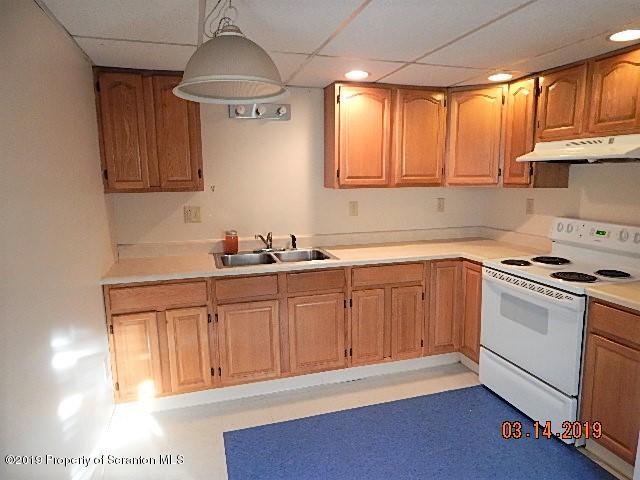 1763 Ridge Road Montrose, PA 18801 - Photo 13 of 26 a kitchen with granite countertop a sink cabinets stainless steel appliances and a window