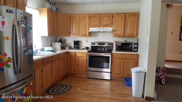1763 Ridge Road Montrose, PA 18801 - Photo 5 of 26 a kitchen with a sink stove and refrigerator