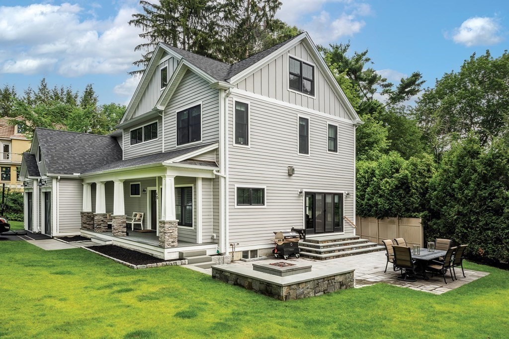46 Tamworth Road Newton, MA 02468 - Photo 12 of 12 a white house with a large pool lawn chairs and a yard