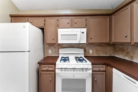 a kitchen with a stove and a refrigerator