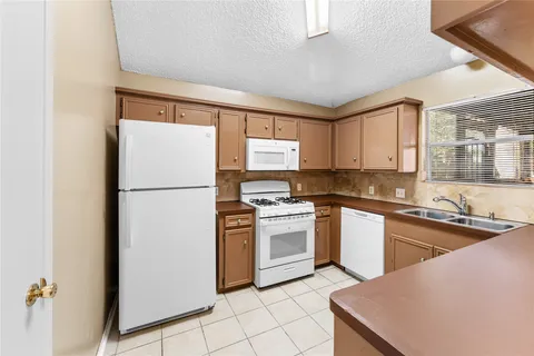 a kitchen with cabinets and stainless steel appliances