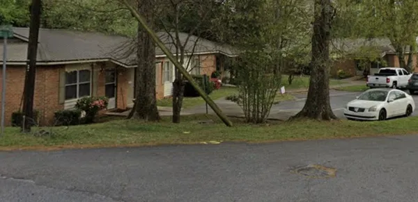 a view of a house with a yard and street
