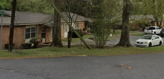 a view of a house with a yard and street