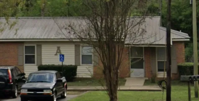 a view of backyard with barbeque grill and outdoor seating