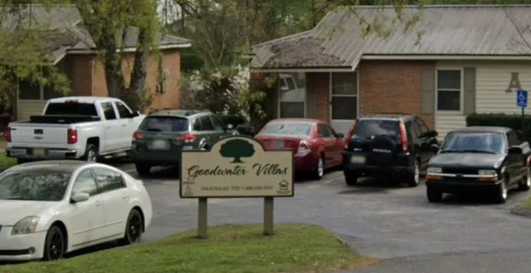 a view of cars parked in front of a house