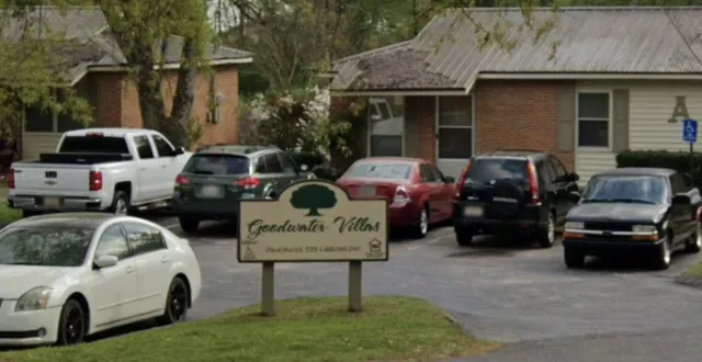 a view of cars parked in front of a house