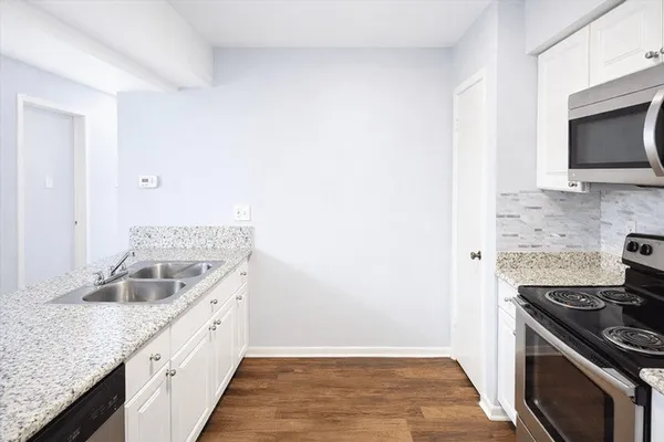 a kitchen with a sink and a stove top oven