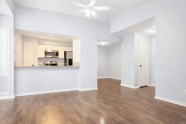 a view of a kitchen with wooden floor and a sink