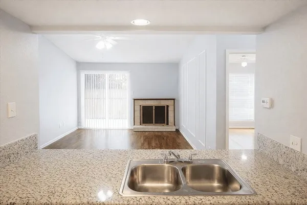 a kitchen with a sink and a large mirror
