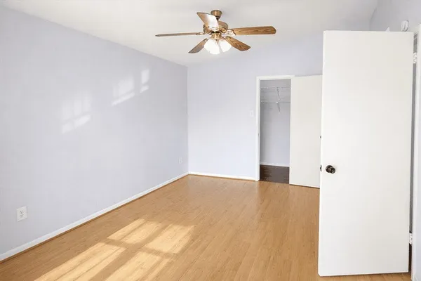 a view of an empty room with a ceiling fan