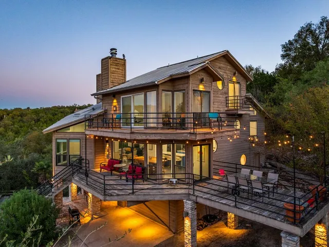 a view of a house with swimming pool and sitting area