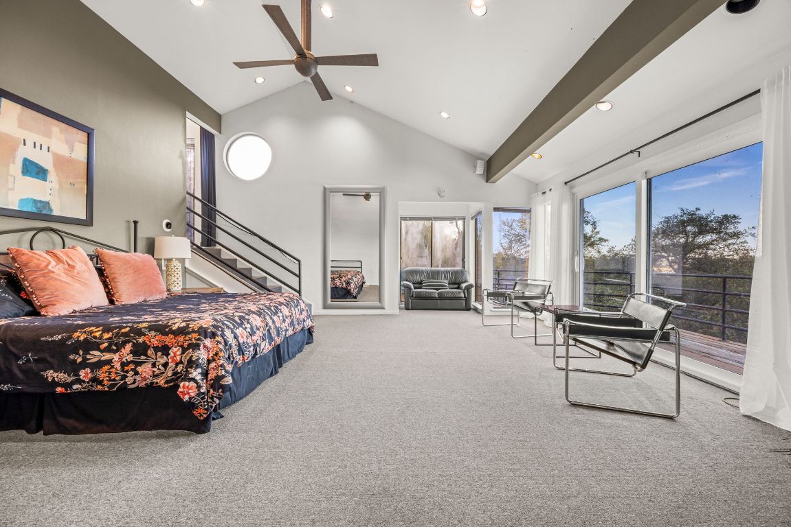 723 Coventry Road Spicewood, TX 78669 - Photo 12 of 40 a bed room with a bed couch and a large window