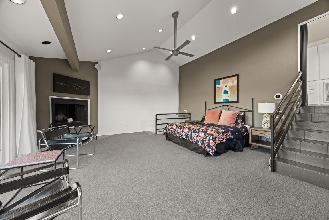 723 Coventry Road Spicewood, TX 78669 - Photo 13 of 40 a bedroom with furniture and a flat screen tv